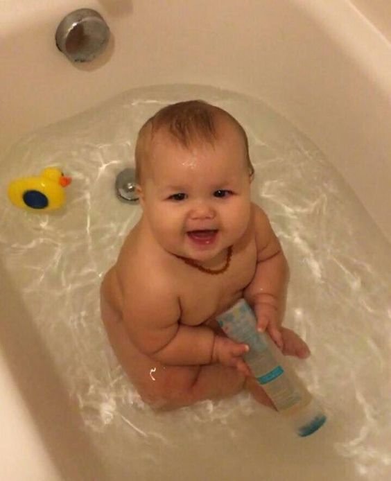 Baby giggles and splashes joyfully, chasing bubbles and cuddling his floating duck in the warm, soothing bath.